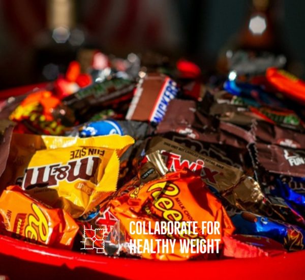 Red bowl filled with leftover fun-size Halloween candy