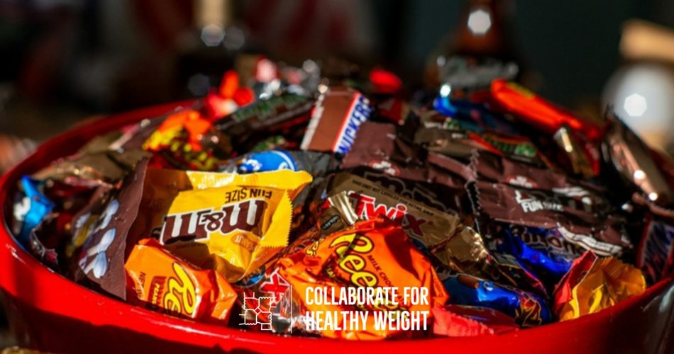 Red bowl filled with leftover fun-size Halloween candy